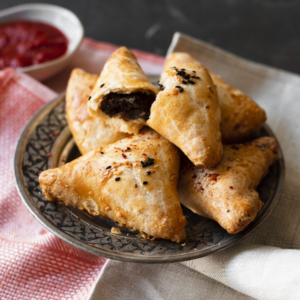 A plate of golden, flaky puffs with a crispy crust.