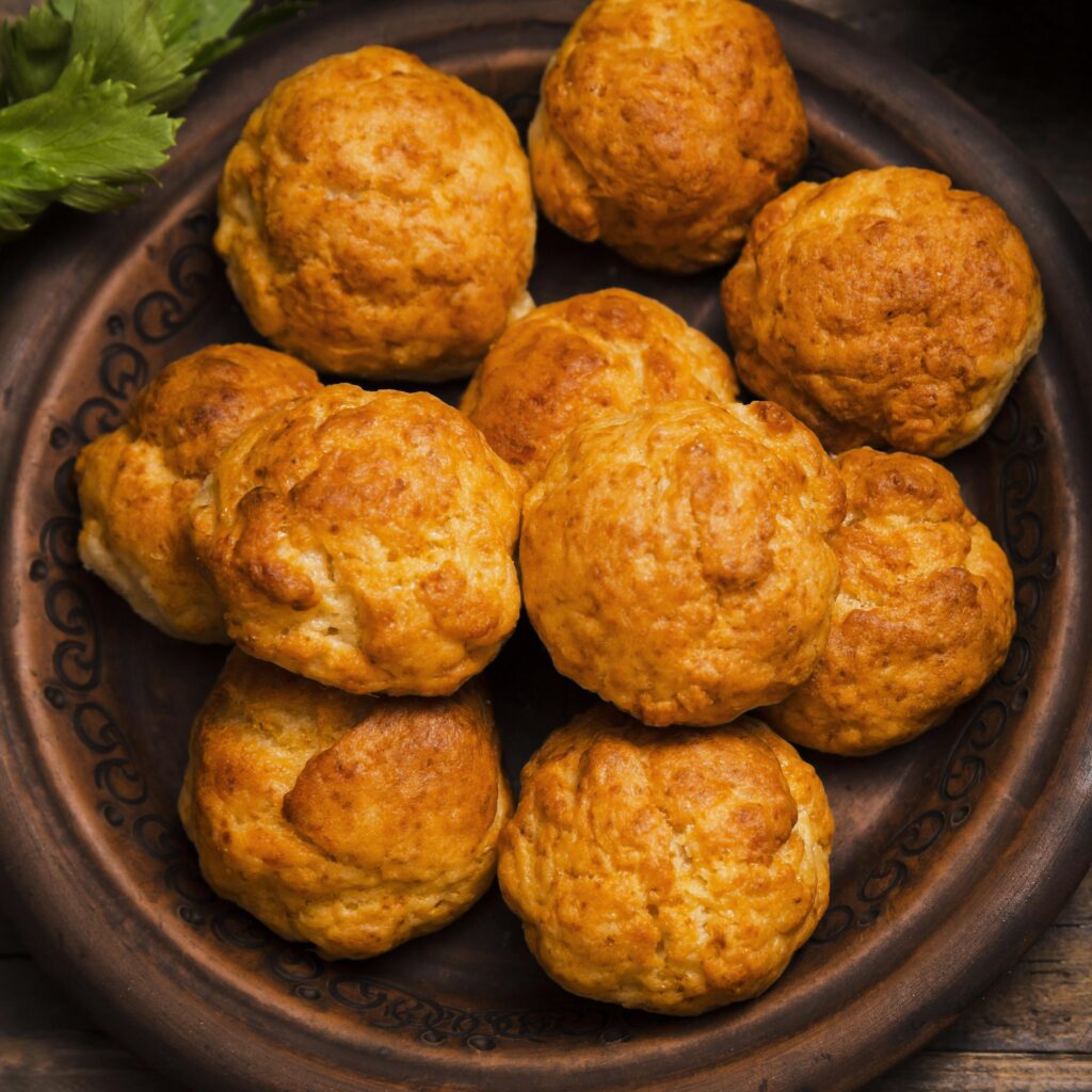 A plate of golden, flaky puffs with a crispy crust.
